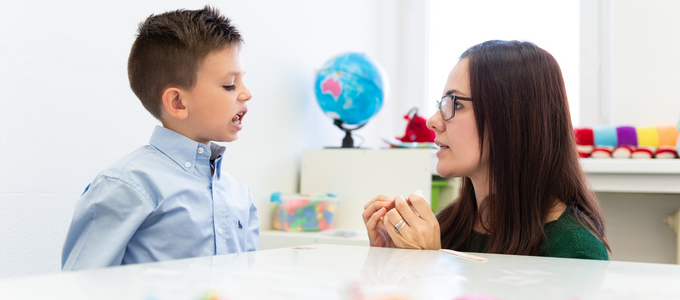 Speech Pathologist assisting young boy