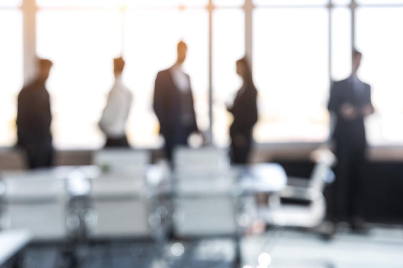 Soft focus image of a group of people in an office setting