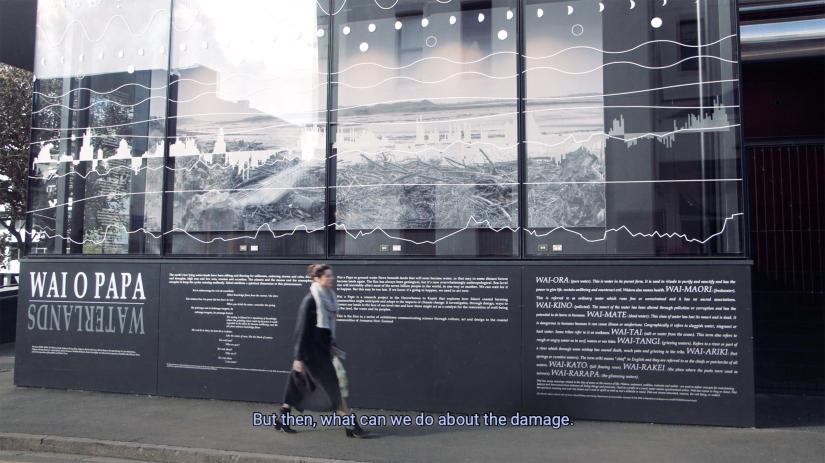 Person walks along footpath in front on Landscape Architecture display entitled Was O Papa Wetlands