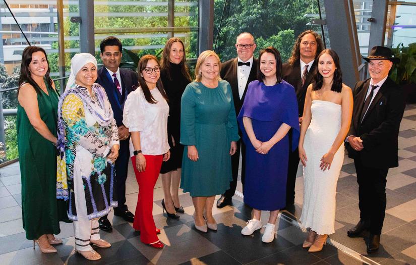 Group of Alumni Award winners with the VC in Black tie dress