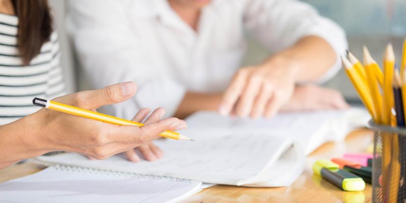 Two people studying at a desk