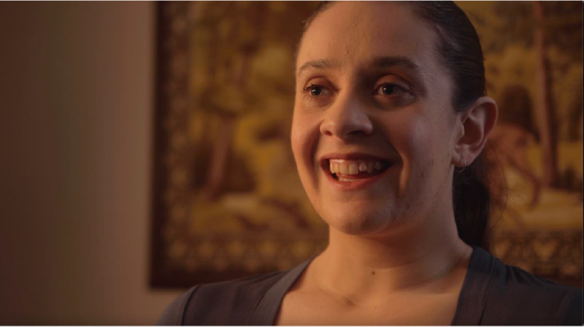 young woman smiling off camera