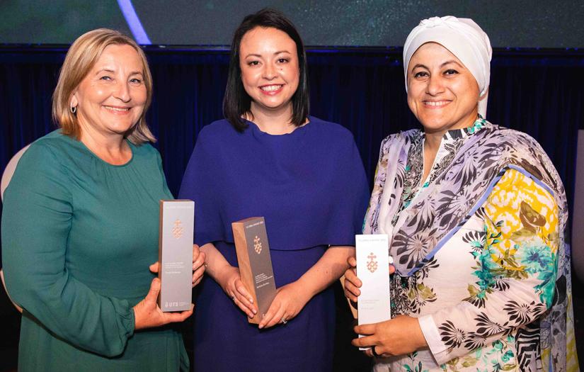 Group of three women smiling and looking at the camera at an Award ceremony