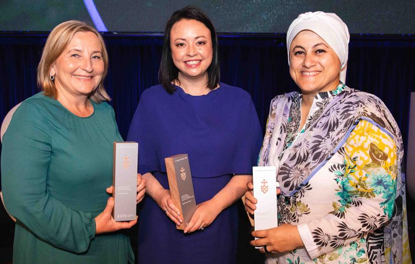 Group of three women smiling and looking at the camera at an Award ceremony