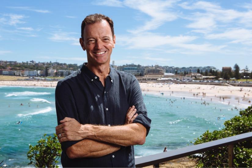 Image of Jason Graham-Nye infront of the beach