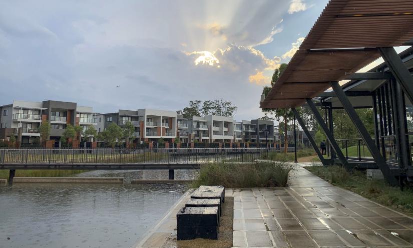 A wide view of the fairwater community showing lake, dwellings and cafe