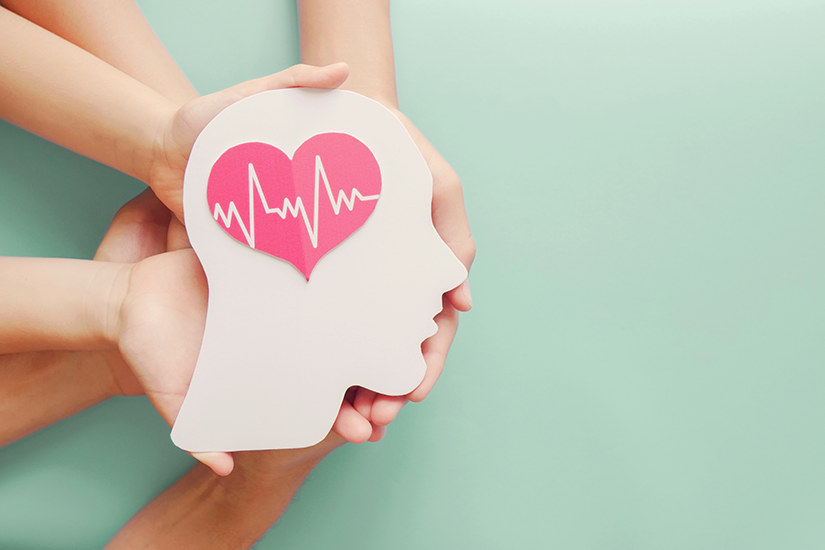 Adult and children hands holding paper brain and heart