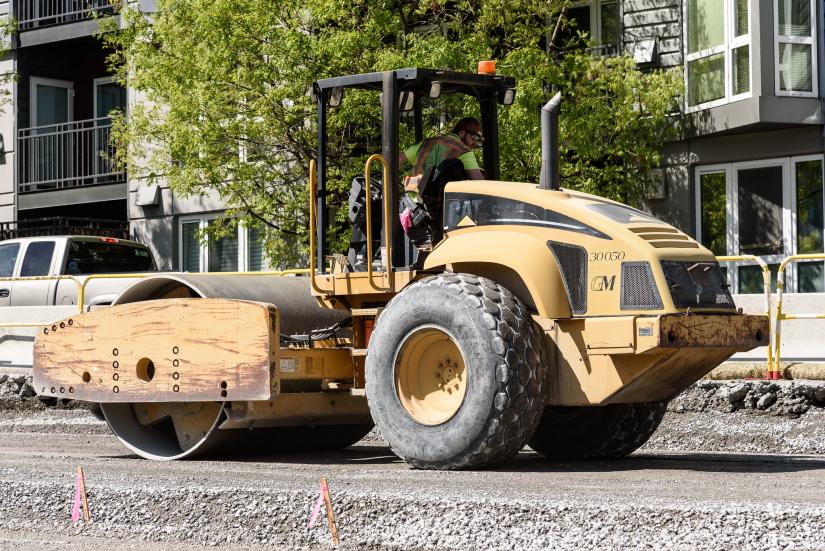 A vibratory roller compacts the road bed. Image: Flickr