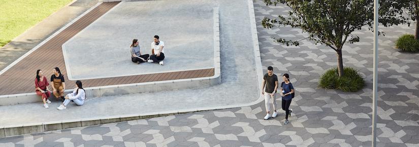 Students sitting or walking through UTS Alumni Green