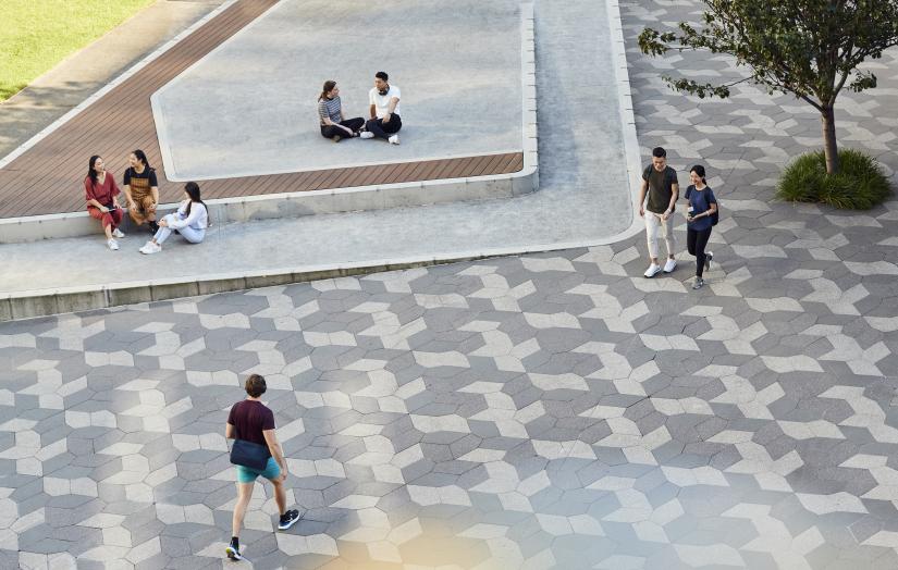 Students sitting or walking through UTS Alumni Green