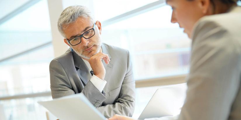 Two people looking at paper notes