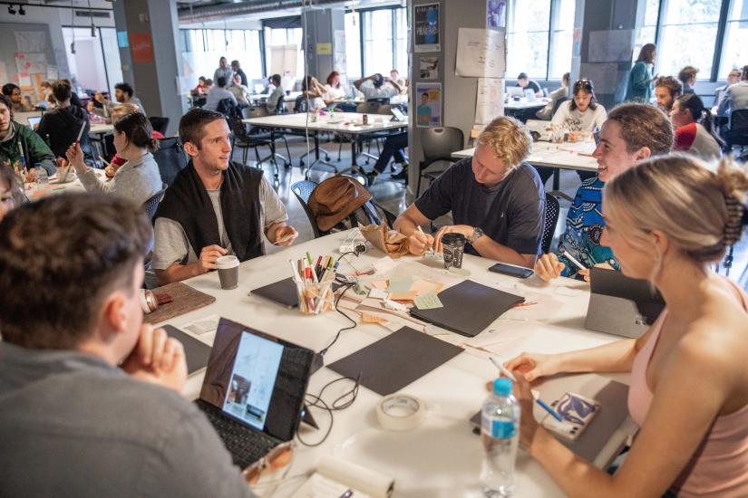 Student team sitting at table collaborating 