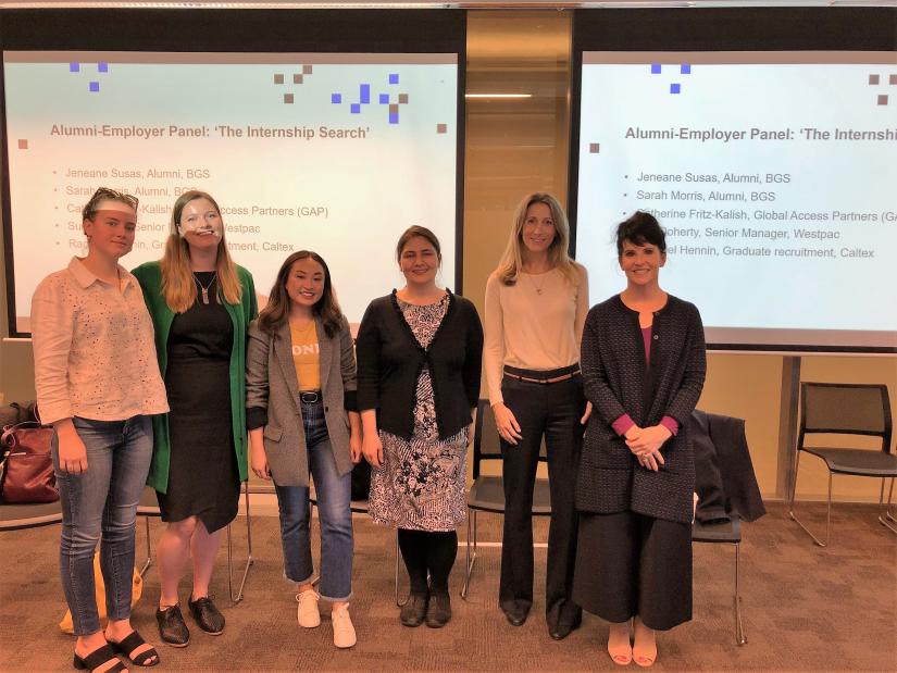 Industry panelists standing in classroom in front of screen with their names