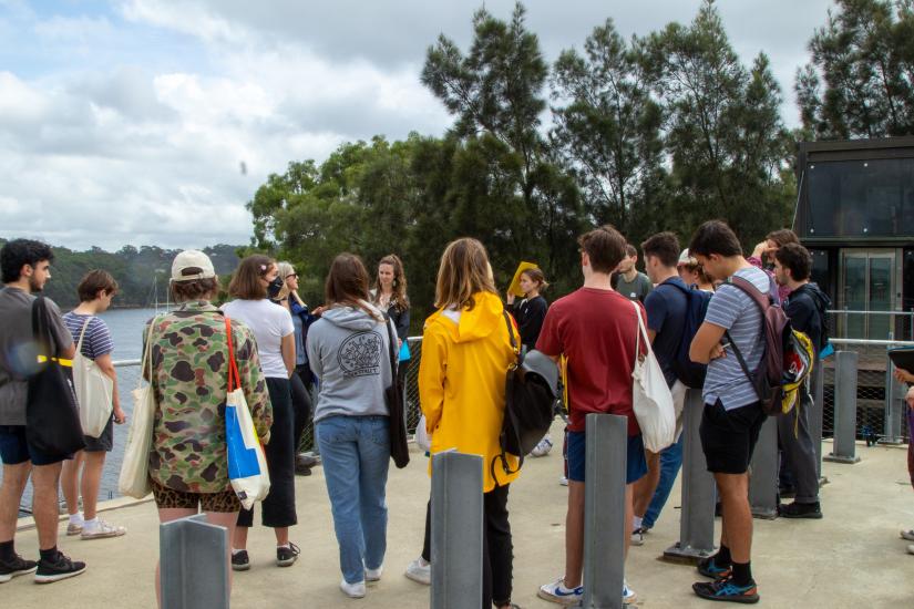 Students standing outside the Coal Loader Centre listening to the centre manager