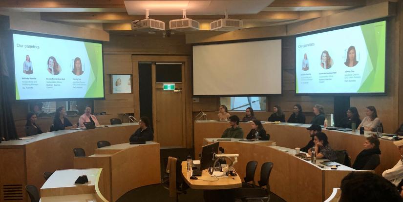 students and panelists sitting in a classroom