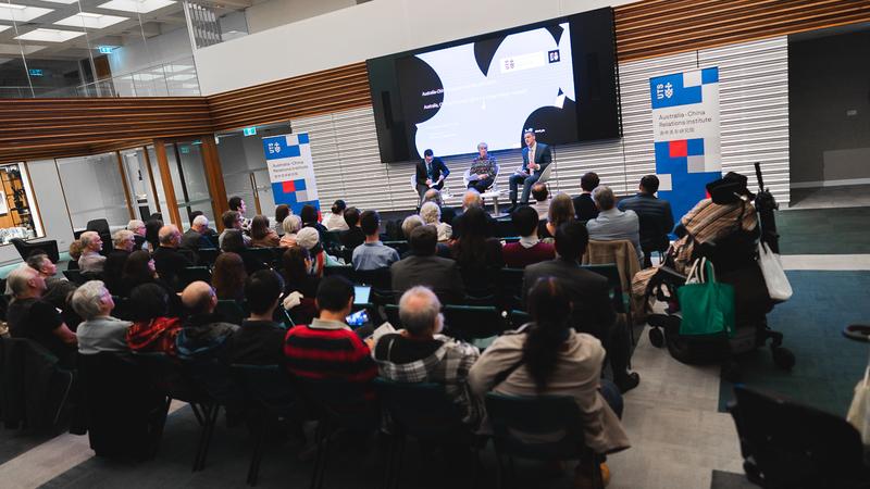 Audience and speakers at the event