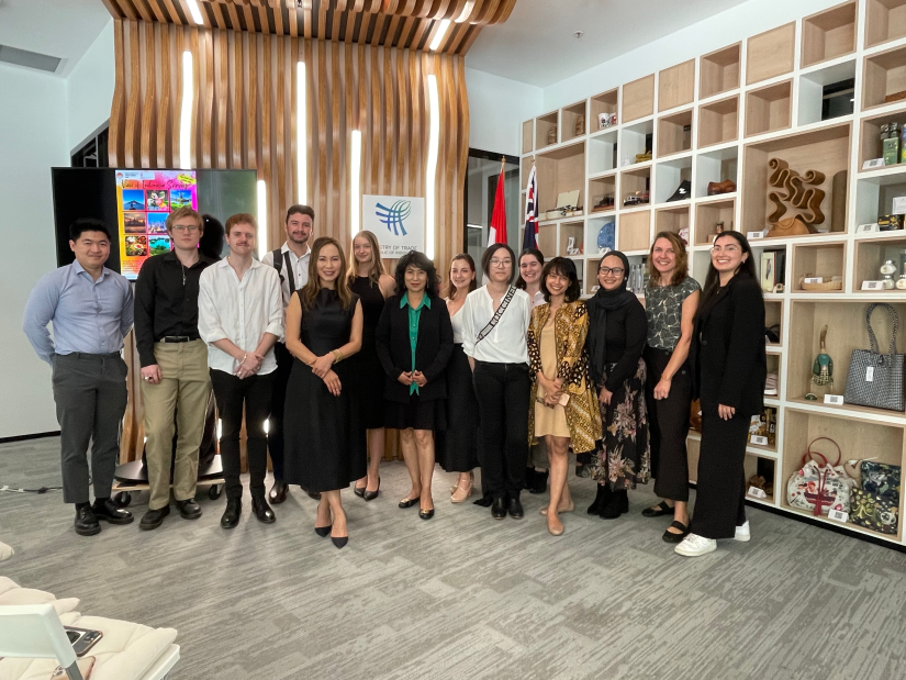 Students and staff smile at camera