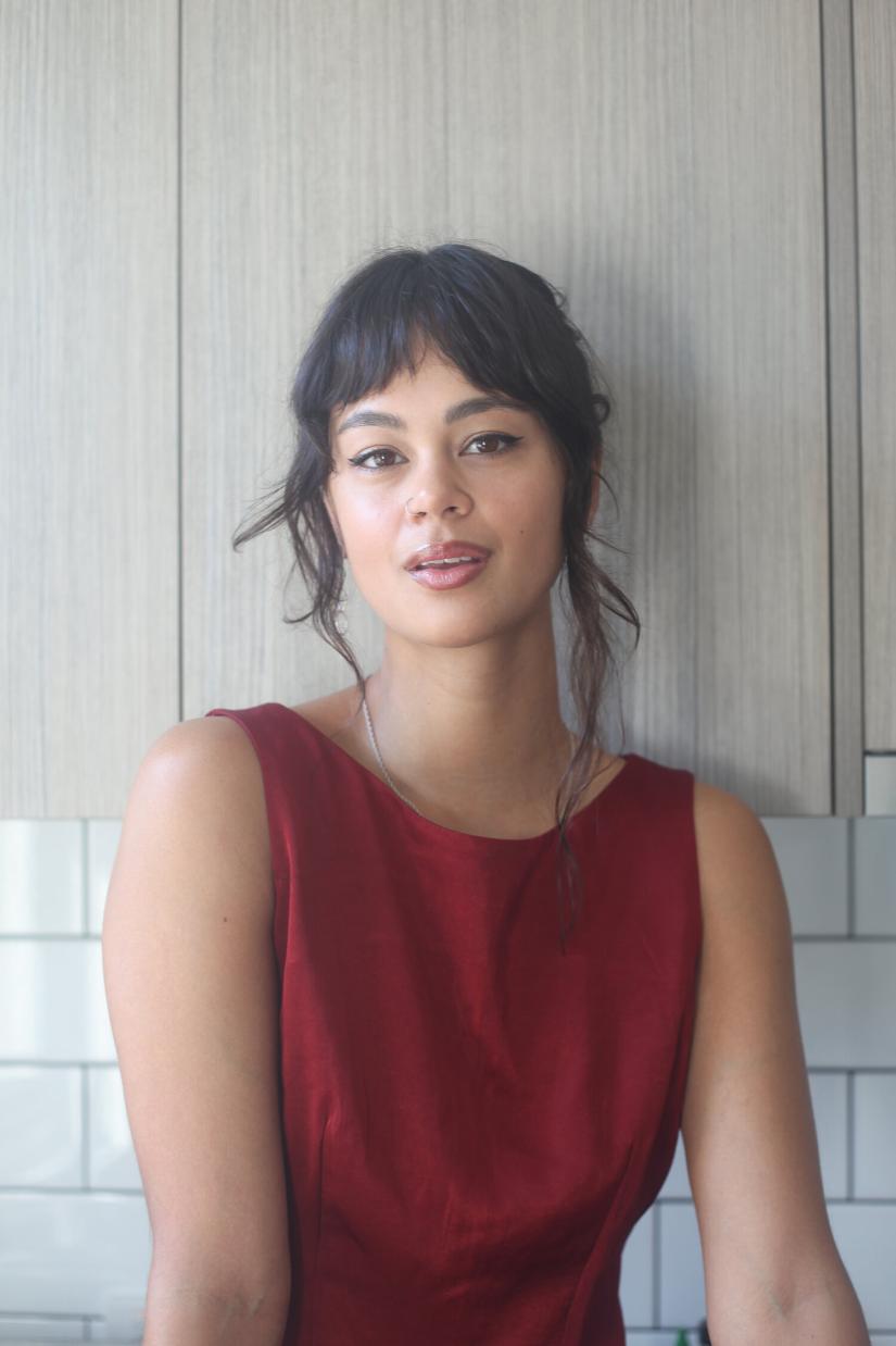 Elfy Scott looks at the camera, wearing a red blouse