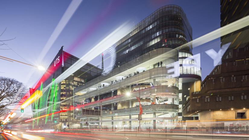 Long exposure image of UTS Tower, Central, and Building 11 at night.