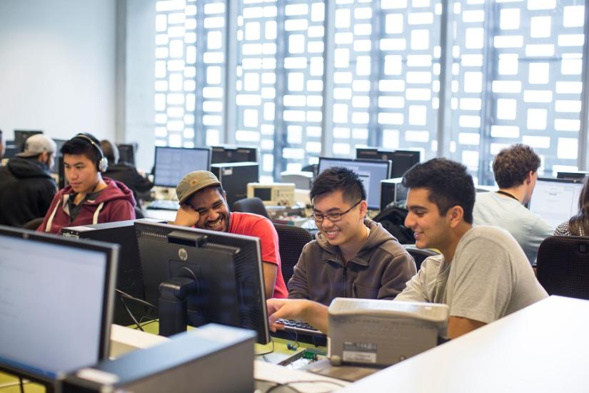 3 students working together at a shared computer 