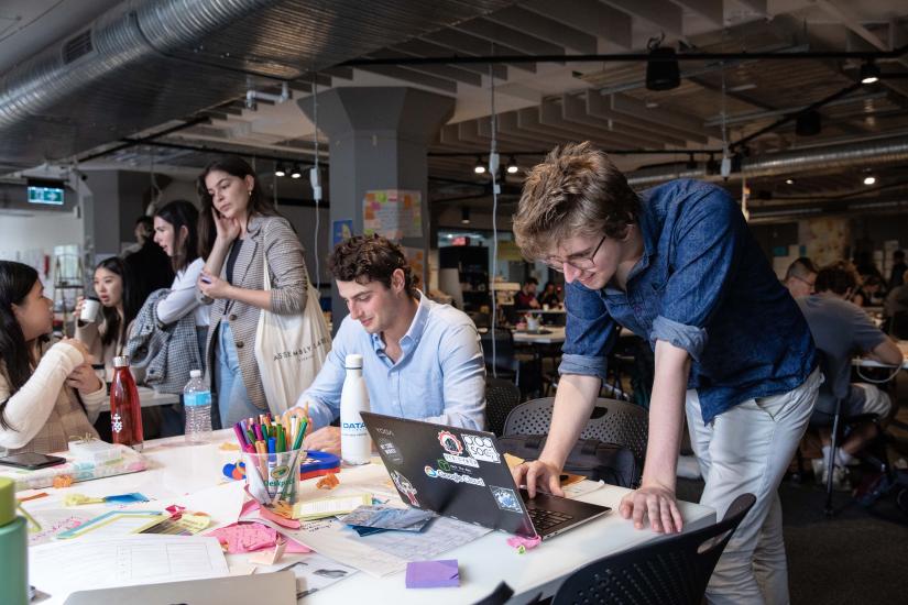 Undergraduate students working at collaborative desk