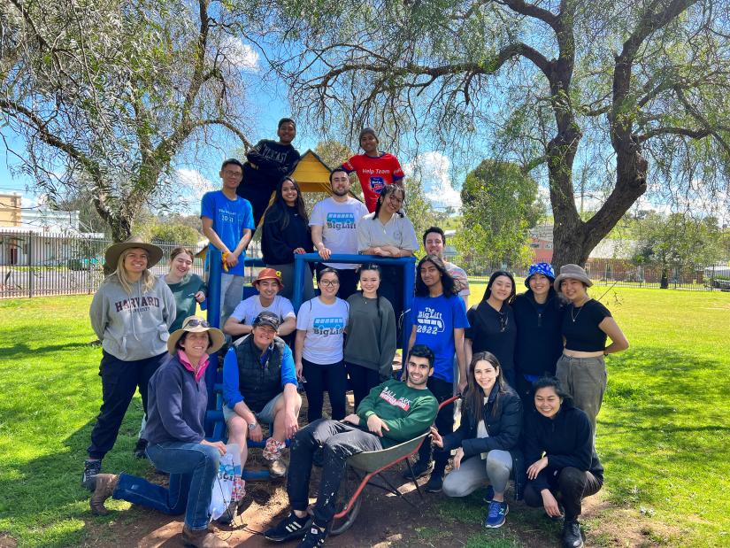 A group of university students smiling during a volunteering activity