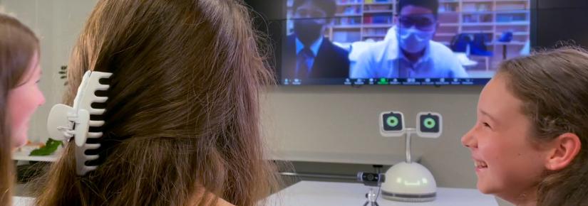 A group of children speak with students via Zoom with Haru the Social Robot facilitating the conversation.