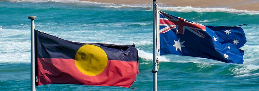 The Aboriginal and Australian flag flying side by side, Bondi Beach in background