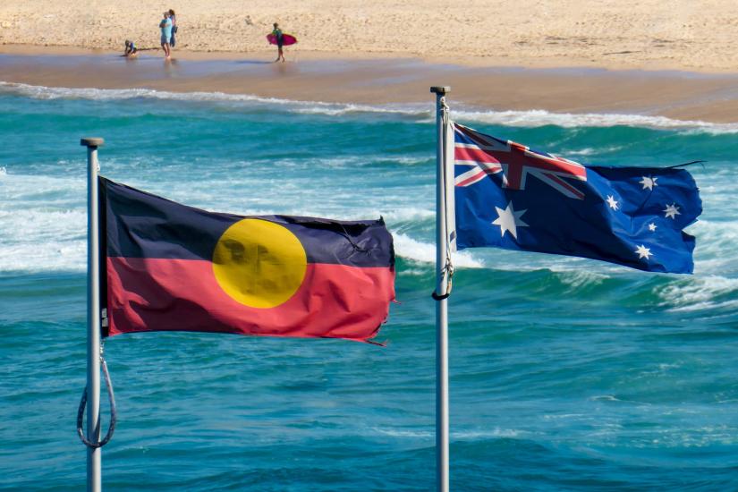 The Aboriginal and Australian flag flying side by side, Bondi Beach in background