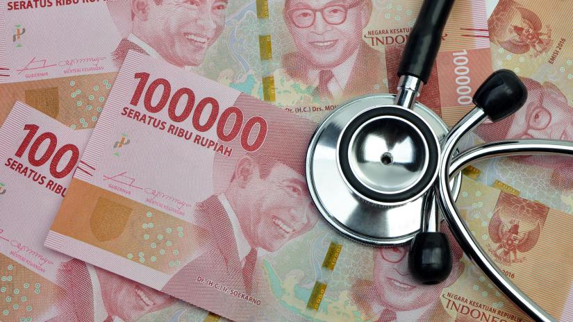 A stethoscope on top of Indonesian rupiah