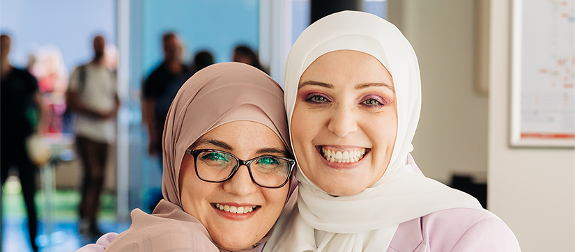 Dr Rayan Saleh Moussa and Nadine El-Kabbout are hugging and smiling at the camera