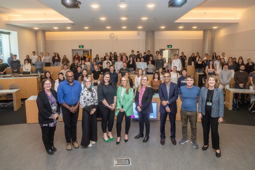 Image of the cohort posing for a photo in the auditorium 