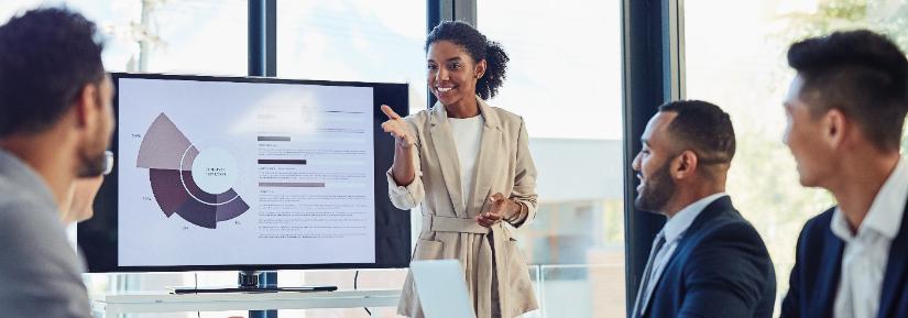 Woman talking to her team in the office boardroom.