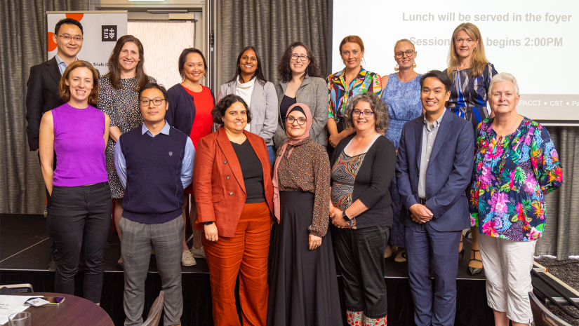 CST Scientific Advisory Committee in two rows at a conference. All facing the camera and smiling.