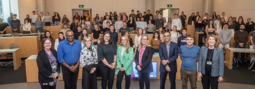 Image of the cohort posing for a photo in the auditorium 