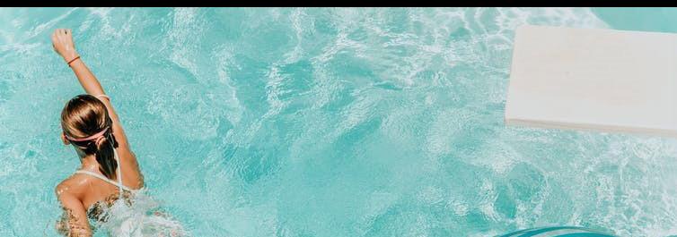 Young girl swimming in pool