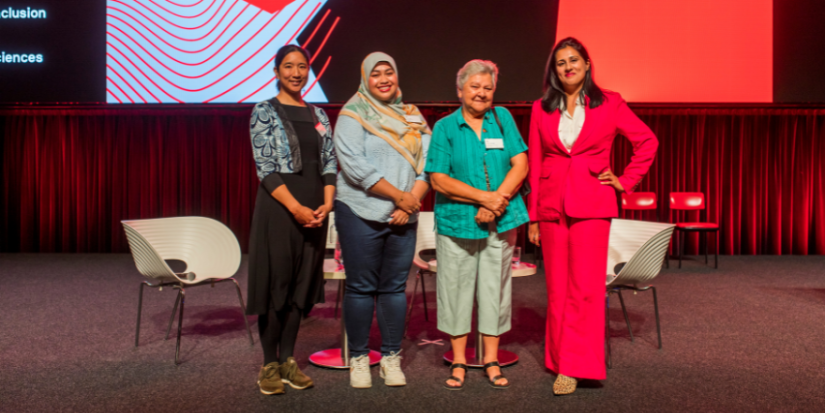 Photo of four women standing in front of the stage