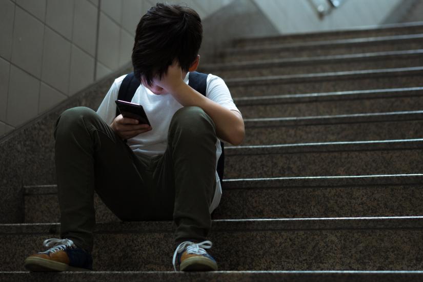 Boy looking at his phone