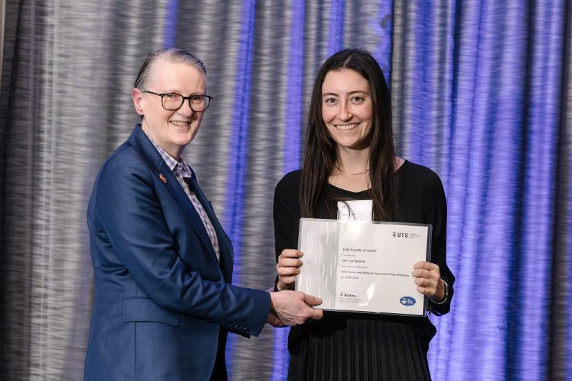 Anne Samuelson presents Amy Meskin with an award