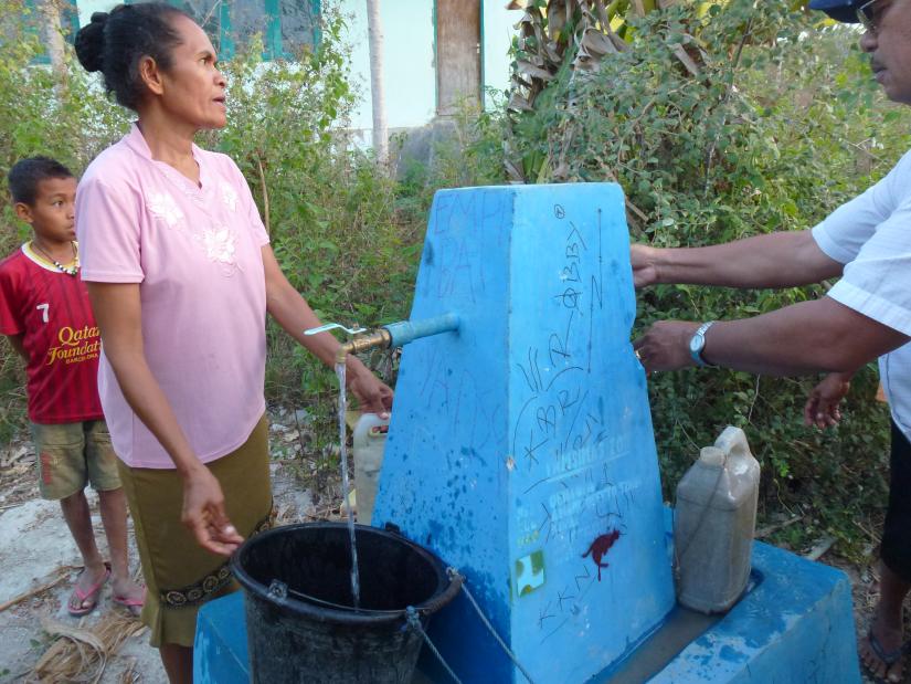 Indonesia outside Kupang - people using a third world water tap