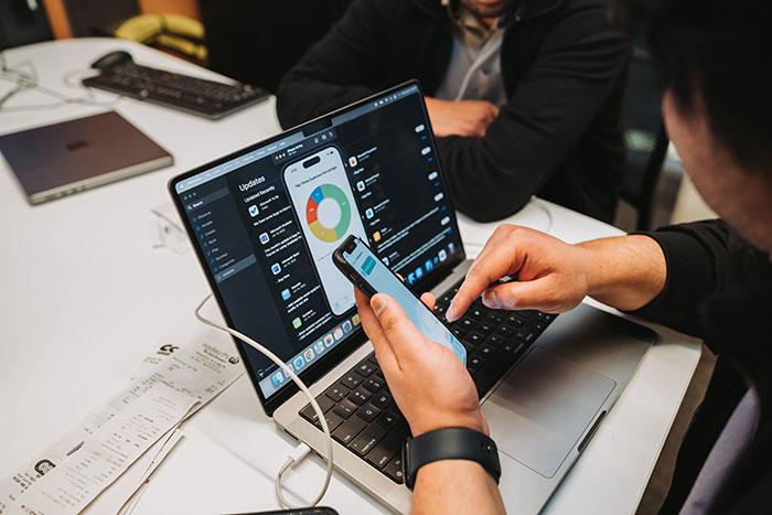 ExpenseTracker iOS application data displayed on laptop and phone