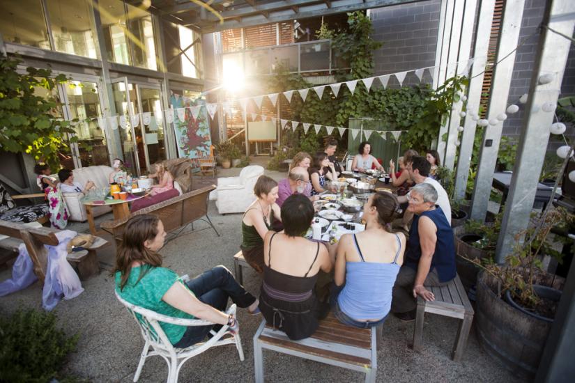 A group of people sit around a table talking