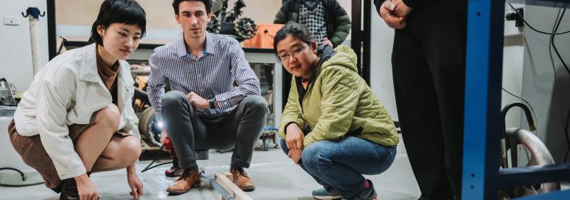 UTS robotics students observe a 'soft robot' grow and navigate a tube during a demonstration for NBN representatives.