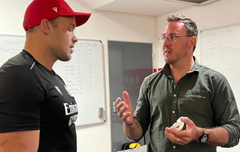 Photo of Matt Jeffriess talking to rugby player