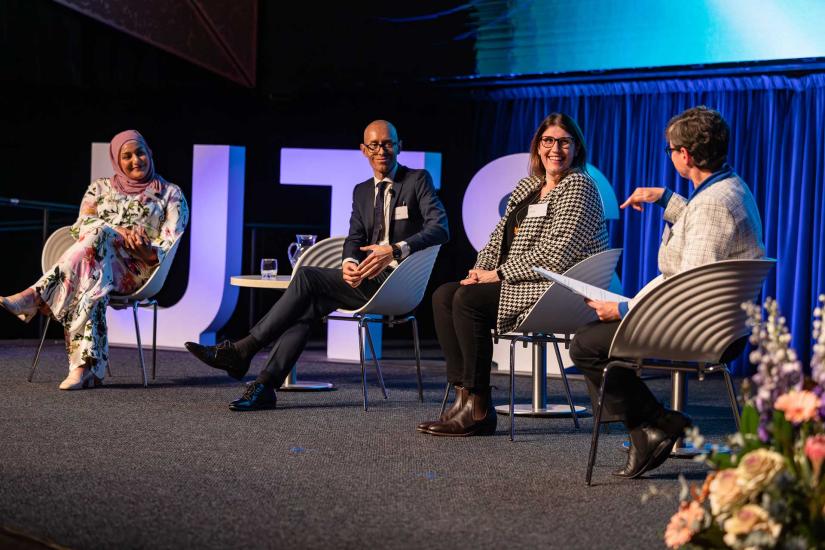 Amani Haydar, Nicholas Stewart and Sarah Dale on stage with Professor Anita Stuhmcke