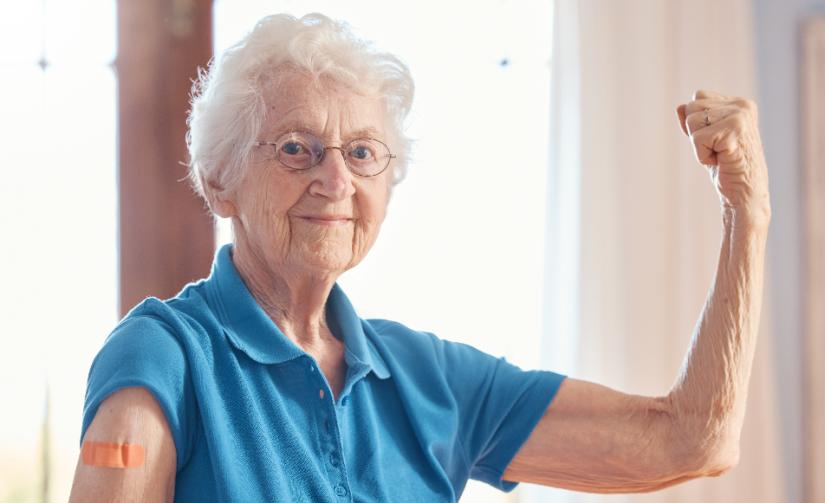 elderly woman flexes arm muscles