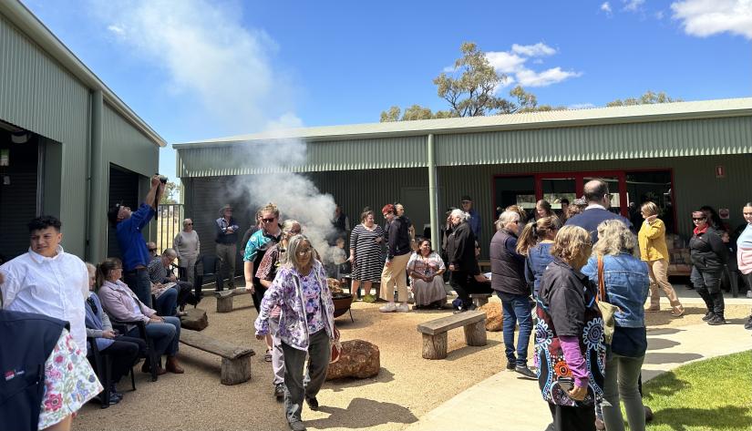 A crowd gathers for a smoking ceremony