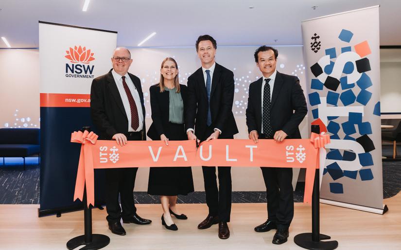 The Vice Chancellor, Dean of the Faculty of Engineering and IT, NSW Premier and fellow government Minister pose with a red ribbon that says 'vault'