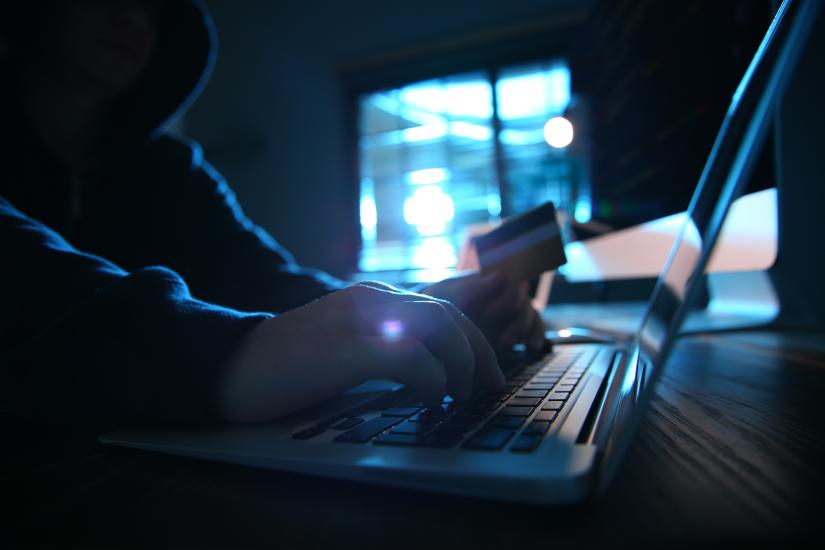 hacker at a computer in a dark room