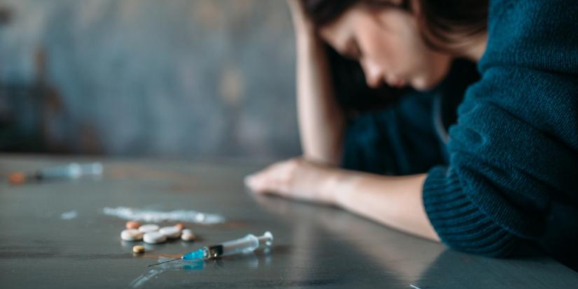 pills and syringe on table